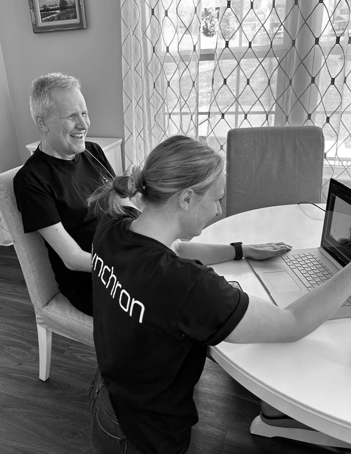 A Synchron team member working hands-on with a participant using the BCI.